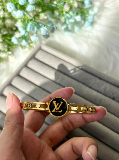 Black stainless steel bracelet accented with gold LV motifs.